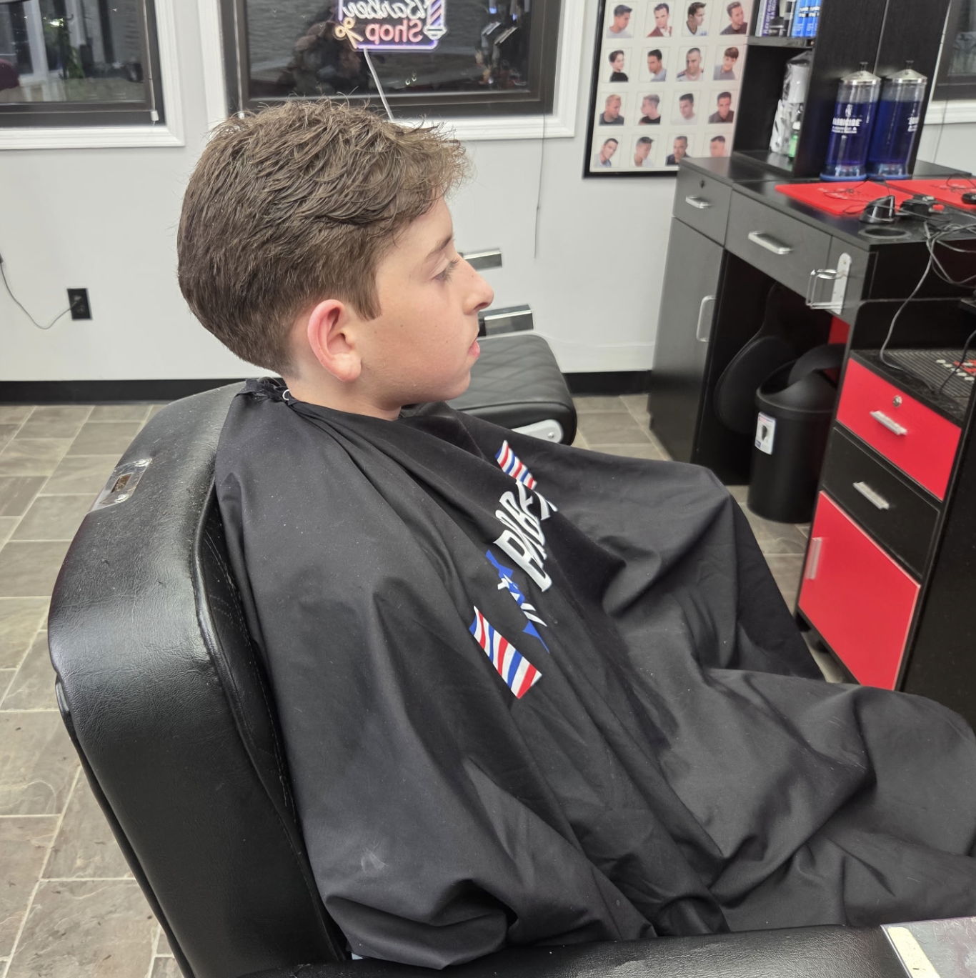 Client showcasing a professional haircut at Ilia's Barbershop